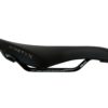 Black racing bicycle saddle with "ninetyx" and "carbon" branding on a white background.