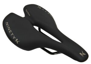 Black bicycle saddle with "Ninety X" and "The Curve" text on it, featuring a cut-out design for comfort.