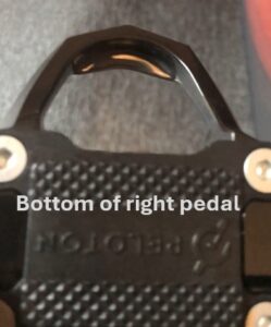 Close-up view of the bottom of a Peloton right pedal, with textured surface and visible clip mechanism.